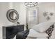 Well-lit bedroom featuring a large mirror and decorative wall art above the bed at 17755 W Onyx Ave, Waddell, AZ 85355