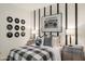 Inviting bedroom featuring unique record decor, industrial-style dressers, and plaid bedding at 17755 W Onyx Ave, Waddell, AZ 85355