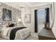 Beautiful bedroom featuring a chandelier, graphic wallpaper, and sleek, modern decor at 17755 W Onyx Ave, Waddell, AZ 85355