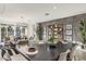 Elegant dining area with modern decor, open to the living room, and features stylish lighting and textures at 17755 W Onyx Ave, Waddell, AZ 85355