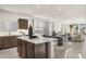 Bright open-concept kitchen features modern appliances and a center island, flowing into the dining and living areas at 17755 W Onyx Ave, Waddell, AZ 85355