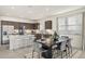 Modern kitchen with stainless steel appliances, a large island with seating, and a view into the dining area at 17755 W Onyx Ave, Waddell, AZ 85355