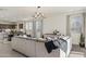Open-concept living space connects the kitchen and living room, complete with modern furnishings and décor at 17755 W Onyx Ave, Waddell, AZ 85355