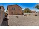 Backyard features low maintenance ground cover and concrete patios at 18475 N Madison Rd, Maricopa, AZ 85139