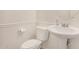 Charming half bathroom with a toilet and pedestal sink at 18475 N Madison Rd, Maricopa, AZ 85139