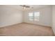 A spacious bedroom boasts natural light, neutral walls, and a ceiling fan at 18475 N Madison Rd, Maricopa, AZ 85139
