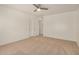 A spacious bedroom boasts neutral walls, carpeted floors, a ceiling fan, and closet space at 18475 N Madison Rd, Maricopa, AZ 85139