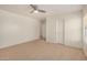 A large bedroom boasts neutral walls, carpeted floors, and a ceiling fan at 18475 N Madison Rd, Maricopa, AZ 85139