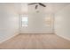 Open bedroom featuring neutral carpet and a ceiling fan at 18475 N Madison Rd, Maricopa, AZ 85139