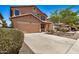 Charming two-story home featuring a two-car garage and low-maintenance desert landscaping at 18475 N Madison Rd, Maricopa, AZ 85139