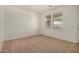 Living room with neutral carpet, and decorative wainscoting at 18475 N Madison Rd, Maricopa, AZ 85139