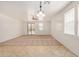 Spacious living room with plush carpeting, neutral walls, ceiling fan, and natural light at 18475 N Madison Rd, Maricopa, AZ 85139