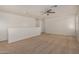 Open loft space with neutral carpet, ceiling fan, and access to other rooms at 18475 N Madison Rd, Maricopa, AZ 85139