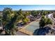 Aerial view featuring a community tennis court nestled among lush greenery, mature trees and nearby homes at 1926 S Longspur Ln, Gilbert, AZ 85295