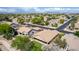 This aerial view showcases the backyard, the outdoor patio and the surrounding houses and streets at 1926 S Longspur Ln, Gilbert, AZ 85295