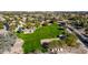 Aerial view of a park with a large green space and playgrounds in a vibrant neighborhood at 1926 S Longspur Ln, Gilbert, AZ 85295