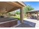 Serene backyard oasis featuring an outdoor spa, covered patio, and a gazebo at 1926 S Longspur Ln, Gilbert, AZ 85295