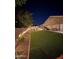 A spacious backyard featuring artificial turf, a gazebo, lush landscape, and plenty of room to relax at 1926 S Longspur Ln, Gilbert, AZ 85295