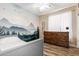 Cozy bedroom with wood-look tile flooring and a beautiful wall mural at 1926 S Longspur Ln, Gilbert, AZ 85295
