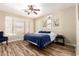 Bright bedroom with neutral walls, ceiling fan, and light-filled windows at 1926 S Longspur Ln, Gilbert, AZ 85295