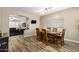 Open dining room with wood-look tile floors, pendant lighting, and access to the living room at 1926 S Longspur Ln, Gilbert, AZ 85295