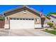 Two-car garage and neutral stucco siding on a lovely single Gathering home at 1926 S Longspur Ln, Gilbert, AZ 85295