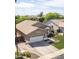 A view of the house highlighting its brick driveway, two car garage, and well landscaped front yard at 1926 S Longspur Ln, Gilbert, AZ 85295
