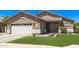 Charming single-story home featuring an attached two-car garage, manicured lawn, and desert landscaping at 1926 S Longspur Ln, Gilbert, AZ 85295