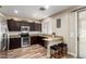 Charming kitchen with stainless steel appliances, granite countertops, and dark wood cabinets at 1926 S Longspur Ln, Gilbert, AZ 85295