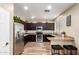 Modern kitchen with stainless steel appliances, dark wood cabinets, granite counters, and tile backsplash at 1926 S Longspur Ln, Gilbert, AZ 85295