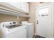 Functional laundry room with updated appliances, shelving, and exterior access at 1926 S Longspur Ln, Gilbert, AZ 85295
