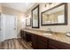 Spacious bathroom featuring double sinks, granite countertops, and dark wood cabinets at 1926 S Longspur Ln, Gilbert, AZ 85295