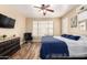 Neutral main bedroom featuring a ceiling fan, TV, and cozy seating at 1926 S Longspur Ln, Gilbert, AZ 85295