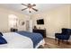 Relaxing main bedroom featuring ensuite access, a ceiling fan, and a dark dresser at 1926 S Longspur Ln, Gilbert, AZ 85295