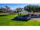 Park featuring a picnic table under a shaded canopy on a sunny day surrounded by green space at 1926 S Longspur Ln, Gilbert, AZ 85295