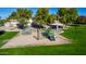 A playground with climbing nets, slides, and shade canopies amidst mature trees in the community at 1926 S Longspur Ln, Gilbert, AZ 85295
