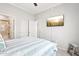 Bright bedroom features a large bed, a mounted television, and access to the bathroom and closet at 19475 N Grayhawk Dr # 1128, Scottsdale, AZ 85255