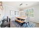Bright dining area with a farmhouse-style table, stylish seating, and large windows for natural light at 19475 N Grayhawk Dr # 1128, Scottsdale, AZ 85255