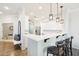 Bright kitchen with a breakfast bar, white cabinetry, and modern pendant lighting for a contemporary feel at 19475 N Grayhawk Dr # 1128, Scottsdale, AZ 85255