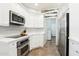 White kitchen with stainless steel appliances and granite countertops at 19475 N Grayhawk Dr # 1128, Scottsdale, AZ 85255
