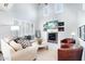 Inviting living room with a cozy fireplace, comfortable seating, and ample natural light creating a warm ambiance at 19475 N Grayhawk Dr # 1128, Scottsdale, AZ 85255