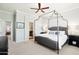 Cozy main bedroom featuring a canopy bed, neutral decor, and ensuite bathroom access at 19475 N Grayhawk Dr # 1128, Scottsdale, AZ 85255