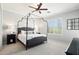 Relaxing main bedroom features a canopy bed, ceiling fan, and shuttered windows at 19475 N Grayhawk Dr # 1128, Scottsdale, AZ 85255