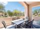 Covered patio with a tiled table, seating for six, and peaceful desert views at 19475 N Grayhawk Dr # 1128, Scottsdale, AZ 85255