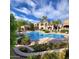 Resort-style pool with lush landscaping, a covered gazebo, and clear blue skies for ultimate relaxation at 19475 N Grayhawk Dr # 1128, Scottsdale, AZ 85255