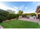 Beautifully landscaped backyard with green grass, decorative fountain, built-in barbecue, and ample space for outdoor enjoyment at 21602 N 36Th St, Phoenix, AZ 85050