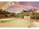 Relaxing backyard with green turf, lighting, brick pavers, and water feature for outdoor enjoyment at 21602 N 36Th St, Phoenix, AZ 85050