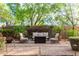 Inviting backyard patio featuring a cozy seating area, lush greenery, and a well-maintained brick surface at 21602 N 36Th St, Phoenix, AZ 85050