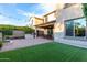 Spacious backyard featuring a built-in BBQ, covered patio, manicured grass, and a paved area, ideal for relaxation at 21602 N 36Th St, Phoenix, AZ 85050