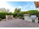 Lush backyard with water feature, built-in grill station, and paved patio for relaxing and entertaining outdoors at 21602 N 36Th St, Phoenix, AZ 85050
